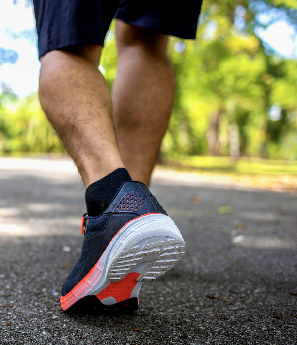 Picture of a man's legs in a pair of running shoes.